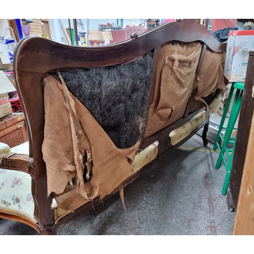 396 - Star Lot : A horse hair original Victorian three-seater sofa with intricate carved wooden detailing,... 