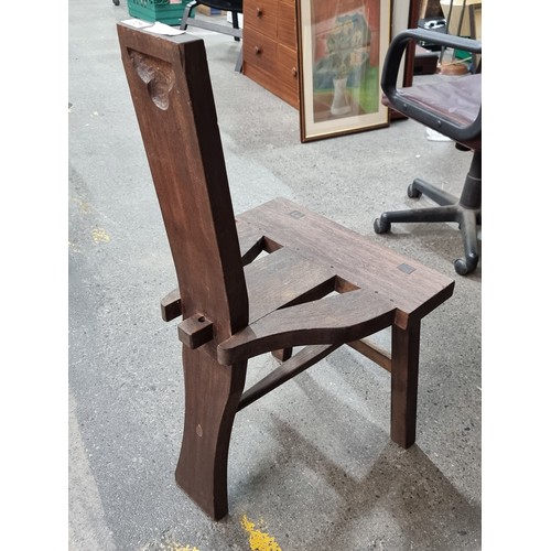 422 - A three legged Irish Tuam / Sligo chair in stained teak wood. Simple straight back rest also reminis... 