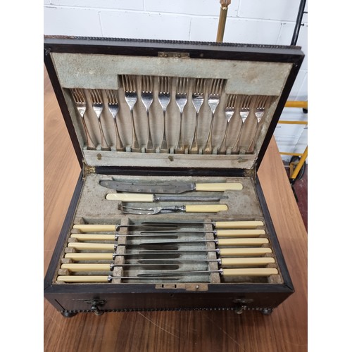 878 - A beautiful vintage cutlery set housed in a fabulous display case with pull out drawer, brass fittin... 