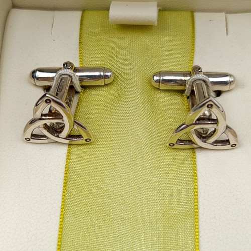 20 - A pair of sterling silver Celtic Harmony cuff links, featuring original presentation case.