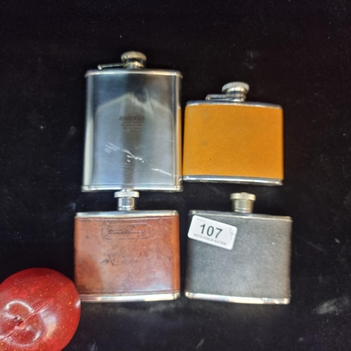 107 - Four hip flasks including an Irish made Peterson example.