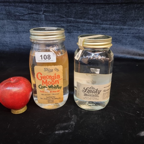 108 - Two glass jars of moonshine including a sealed Georgia Moon Corn Whiskey example (75cl) and Ole Smok... 