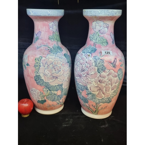 125 - A pair of large Chinese ceramic vases featuring a rose motif in shades of pink and green. In very go... 