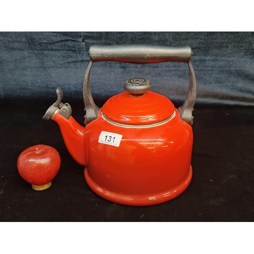 131 - A large  red Le Creuset enamelled kettle with a whistle spout and lid. In good order. RRP €106