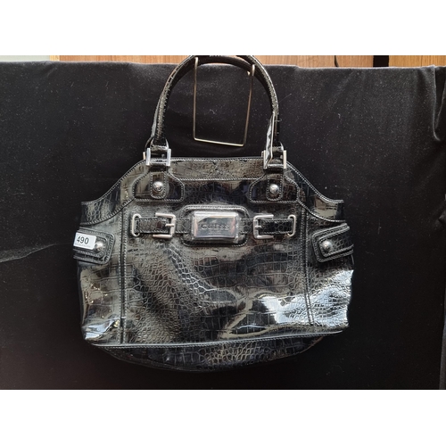 490 - A large Guess shoulder bag in a patent black croc leatherette. With silver toned hardware throughout... 