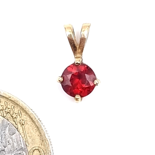 58 - A intricate hallmarked 9 carat gold Garnet stone pendant.