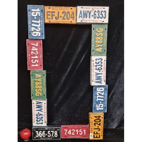 98 - An unusual painted metal frame in the form of American State car license plates. Would make a fun mi... 