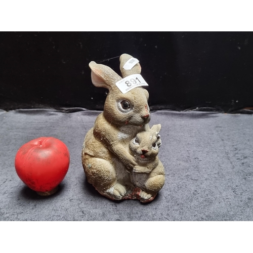 891 - A very characterful garden figure depicting a rabbit with its baby.