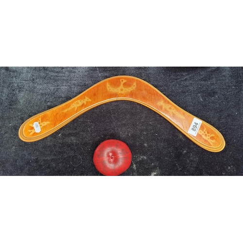 894 - An Australian made 18 inch wooden boomerang with a kangaroo and bird motif.