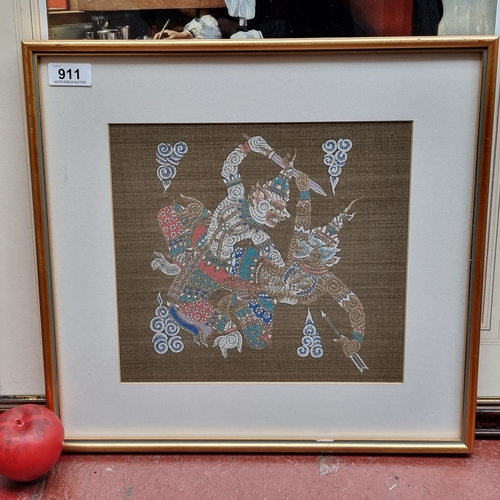 911 - A print on silk of a traditional Thai scene showing warriors in battle. Housed in a smart gilt frame... 