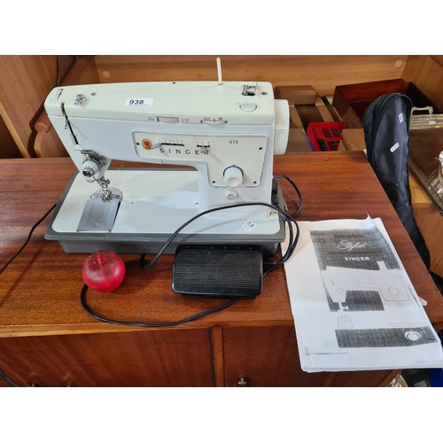 938 - A vintage Singer sewing machine model 413. Comes with a pedal and is fitted with a three-pronged plu... 