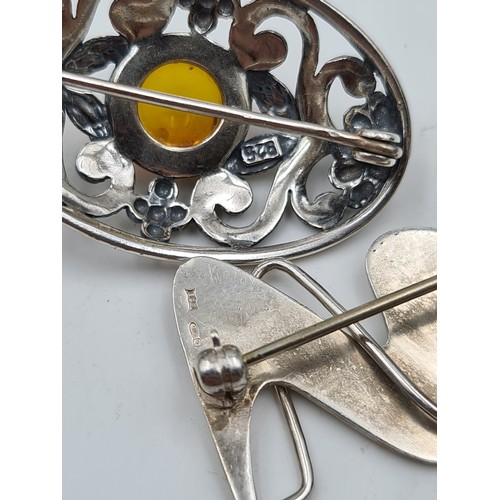 11 - A collection of two Sterling silver brooches, the first with a fabulous natural Amber stone. Total w... 