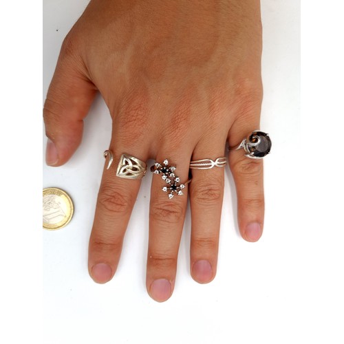 19 - Four stunning sterling silver rings, the first two are set with sparkling gem stone detail and a Smo... 