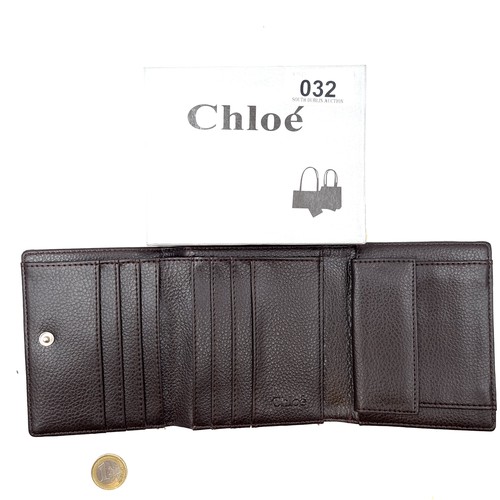 31 - A designer as new boxed Jimmy Choo leather wallet, featuring lovely belt detail and interior compart... 