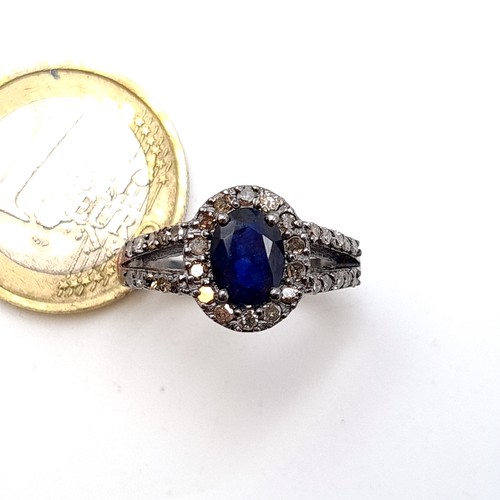 36 - Star Lot : A beautiful Sapphire and Diamond stone ring, featuring fabulous sparkling diamond cluster... 