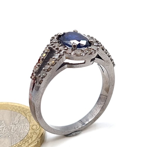 36 - Star Lot : A beautiful Sapphire and Diamond stone ring, featuring fabulous sparkling diamond cluster... 