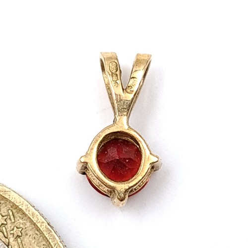 58 - A intricate hallmarked 9 carat gold Garnet stone pendant.