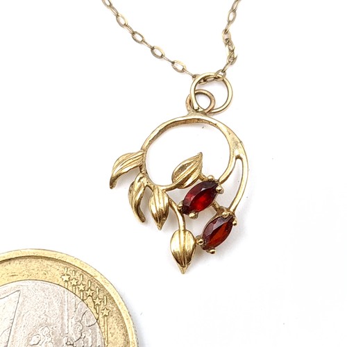 59 - An unmarked gold floral design Garnet stone pedant and chain. Length of chain: 50cm. Weight: 1.8 gra... 