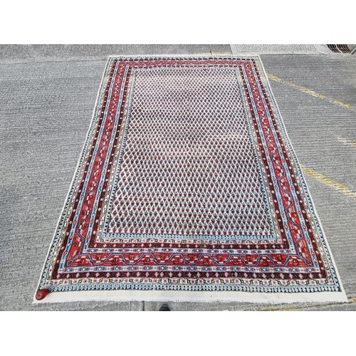 925 - Star Lot: A very large hand knotted wool rug of Indian origin in the classic Persian Sarough mir tep... 