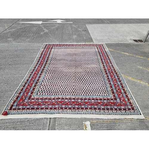 925 - Star Lot: A very large hand knotted wool rug of Indian origin in the classic Persian Sarough mir tep... 