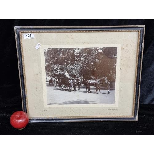 123 - An antique photographic print of a smart Regent Street, London scene with a four horse drawn carriag... 