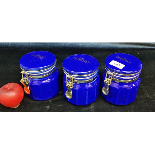 145 - A set of three ceramic Martell Cognac storage jars in a beautiful royal blue colour with brass closu... 