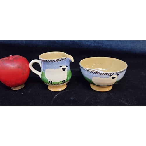 147 - Two Nicholas Mosse items including a creamer and a sugar bowl featuring a sheep design. In very good... 