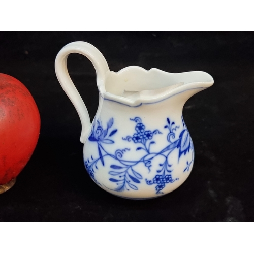 151 - A charming milk jug in the Onion pattern. In very good condition and stamped 'Meissen' to base.