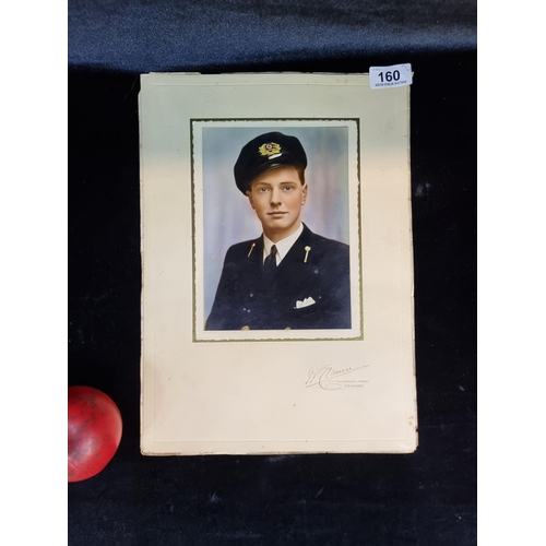 160 - Two vintage photographs of naval interest including a hand colourised portrait depicting a sailor in... 