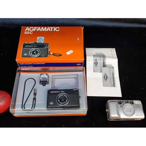 169 - Two film cameras including a Agfamatic 55 C in original box along with a Minolta 115 Riva Zoom. The ... 