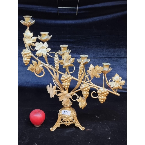 174 - A very ornate gilded candelabra with five branches and a grapevine motif.