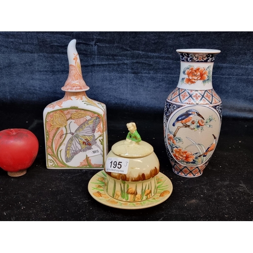 195 - Three ceramic items including an unusual decanter with an organic stopper, vase and a charming sugar... 