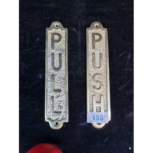 198 - A pair of heavy brass push and pull door plaques.