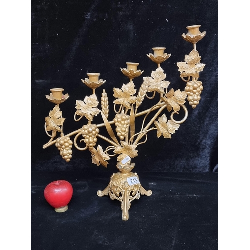 213 - A large striking cast metal five branch candlestick holder boasting beautiful floral and fruit detai... 