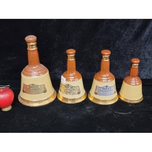 216 - A quartet of vintage Bells Old Scotch Whisky decanters. Made by Wade, circa 1970. (empty)