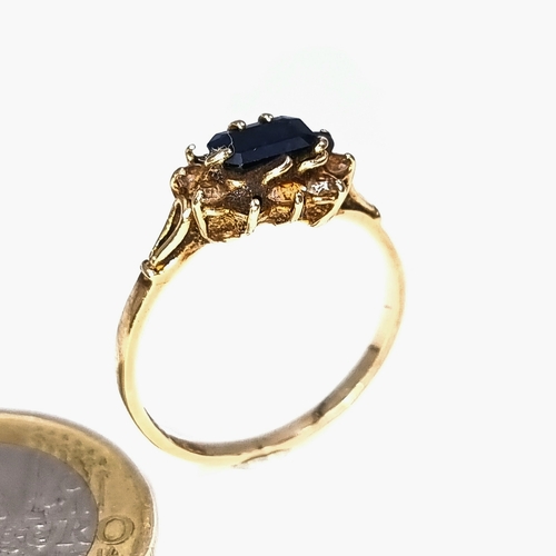 44 - Star Lot : A vintage 9 carat gold set with a Sapphire central stone with gem set surround. Ring size... 