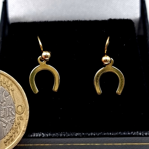 5 - An attractive pair of 9 carat gold horseshoe earrings suitable for pierced ears. 2.2g