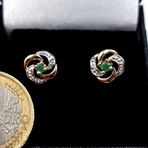 6 - A. very pretty pair of 9 carat gold emerald and gem set swirl stud earrings. Total weight 1.12 grams