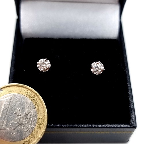 8 - Star Lot : A very pretty pair of bright cut diamond stud earrings set in 9 carat gold. Diamond diame... 