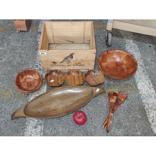 802 - A selection of wooden homeware items including six serving bowls, one large salad bowl and a large u... 