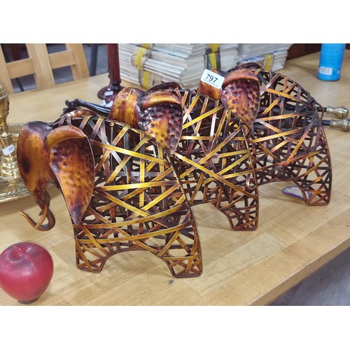 797 - A charming set of three metal elephant sculptures in a painted copper finish.