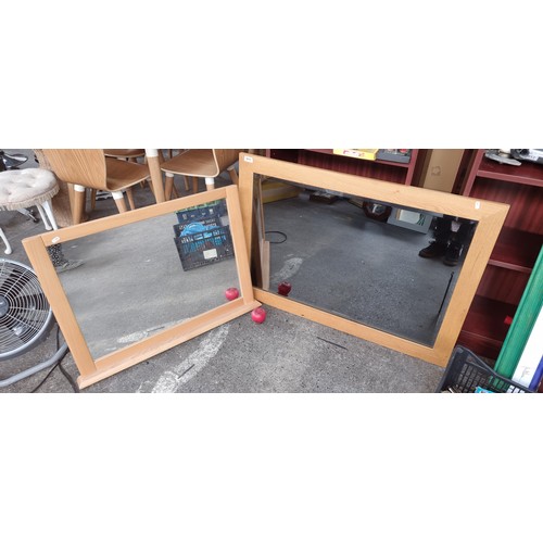 811 - Two large pine mantel mirrors including a beveled example.