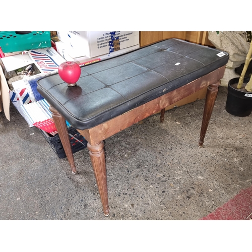 822 - A handsome hall bench with a leather seat to reveal storage. Held on fluted wooden legs. H52cm x W74... 