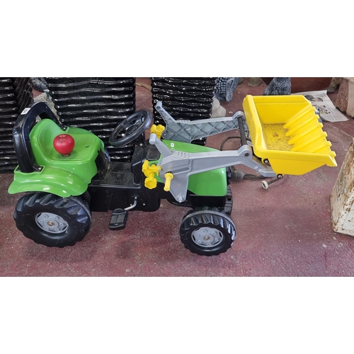 824 - A Rolly Toys toy tractor with pedals and steering wheel.