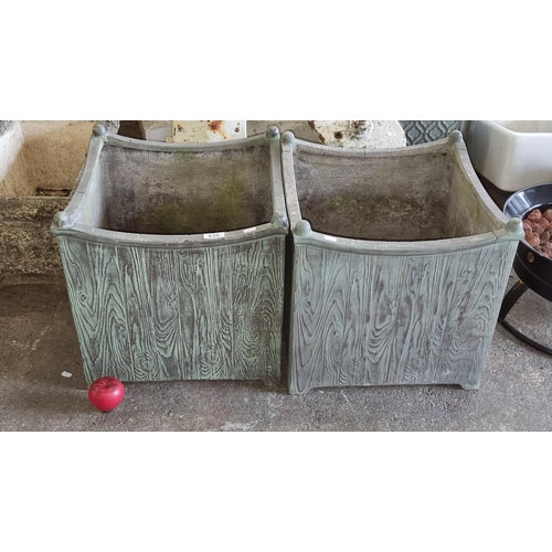 835 - A pair of large stone garden planters with a wood effect finish. H43cm