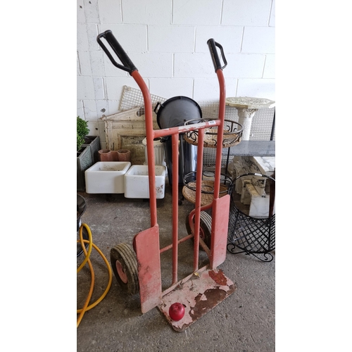 838 - A heavy duty two-wheeler trolley with a platform and two rubber wheels.