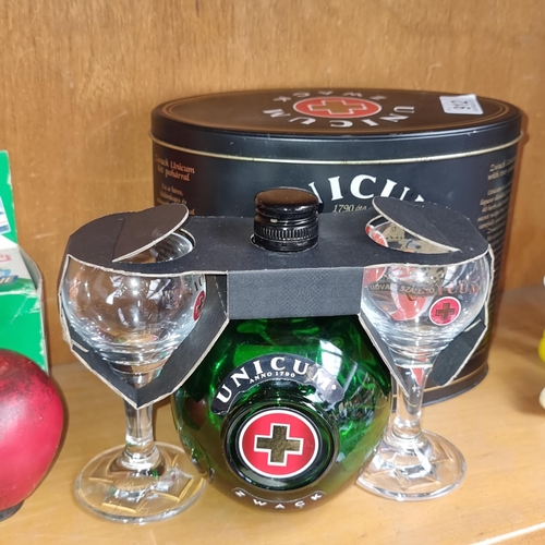 912 - A sealed unopened 0.5L bottle of Unicum Zwack along with two stemmed drinking glasses, housed in ori... 