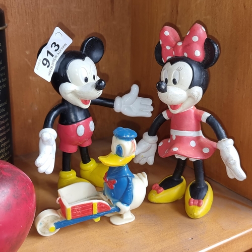 913 - Three vintage Disney figures including Mickey and Minnie Mouse along with Donald Duck figure.