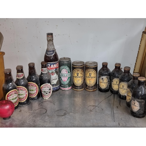 916 - A large selection of vintage sealed alcohol including Murphys, Smithwicks, Guinness. Along with a bo... 