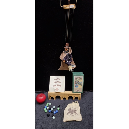 935 - Two charming vintage items comprising of a hand held string puppet and a boxed game of marbles.